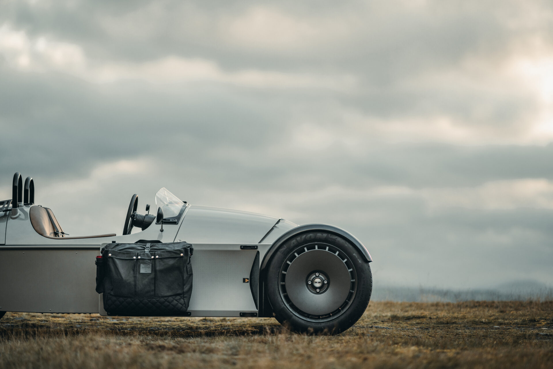 Low angle shot of Super 3 wheel, featuring a Malle dry bag on accessory rack.